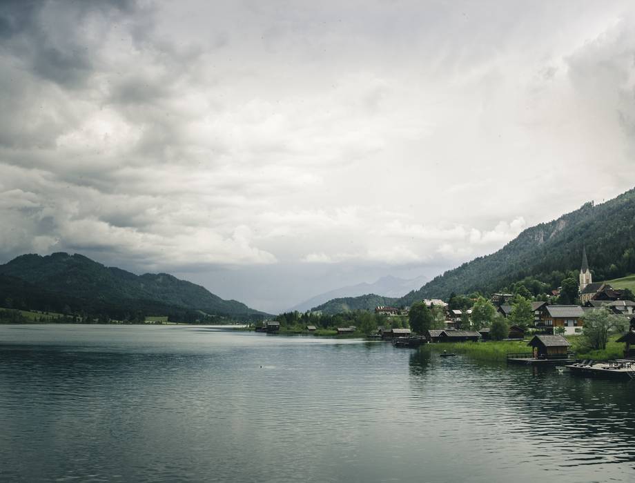 Dorf und Wohnhäuser an einem See in einer Bergregion